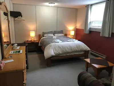a bedroom with a large bed and a window at Stewart Mountain Lodge in Stewart