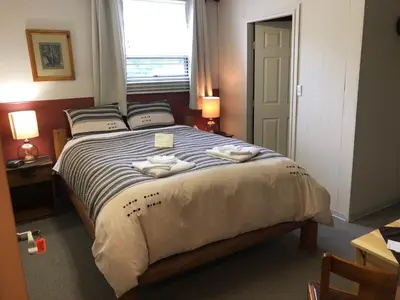 a bedroom with a bed with two towels on it at Stewart Mountain Lodge in Stewart