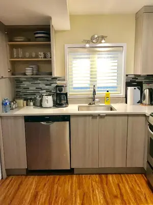 a kitchen with a sink and a dishwasher at Bay View House in Vancouver