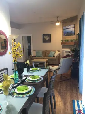 a living room with a table with plates on it at Heart of Peachland in Peachland