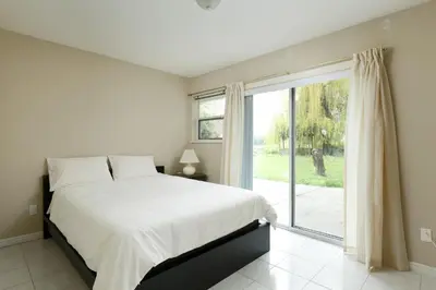 a bedroom with a bed and a large window at Muchen Villa in Delta