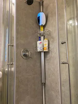 a shower with a glass door and a shower at Richmond Vancouver Airport Comfy Home in Richmond