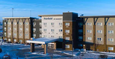 a building with a bench in front of it at Fairfield Inn & Suites by Marriott Airdrie in Airdrie