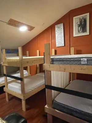 a room with three bunk beds in it at Nanimahoo's Sled N'Bed in Malakwa