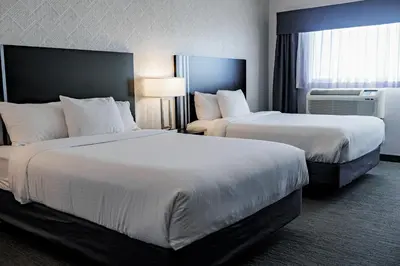 a hotel room with two beds and a window at Park Inn by Radisson Edmonton Airport in Leduc