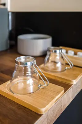two glass pyrex dishes on a wooden cutting board at Boutique in Vancouver