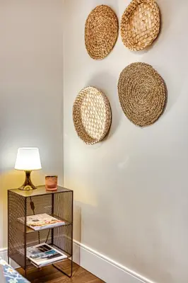 a living room with rattan baskets on the wall at Boutique in Vancouver