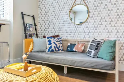a room with a couch with pillows and a mirror at Boutique in Vancouver