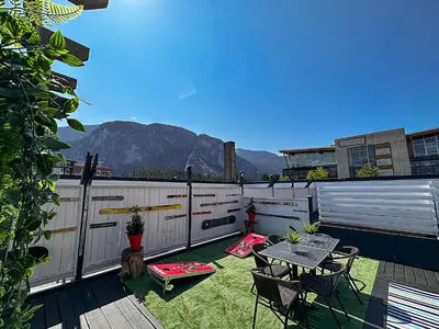 a patio with a table and chairs and a fence at Crash Hotel Squamish in Squamish