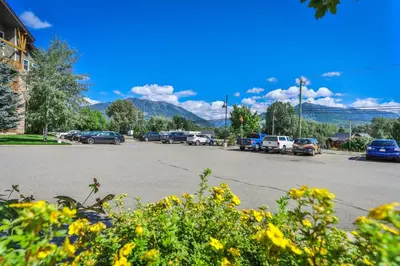 a parking lot with cars parked on the street at Silver Rock by StayIn in Fernie