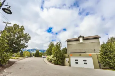 a building with two garage doors on a road at Silver Rock by StayIn in Fernie