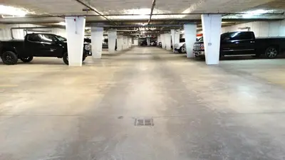 an empty parking garage with cars parked in it at Silver Rock by StayIn in Fernie