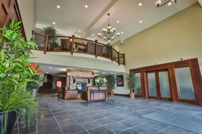 a living room with a staircase and a lobby at Silver Rock by StayIn in Fernie