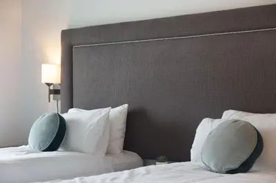a bedroom with two beds with white pillows at Aspens Mountain Side Resort in Whistler