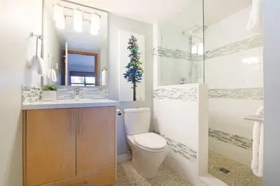 a bathroom with a toilet and a sink and a shower at Aspens Mountain Side Resort in Whistler