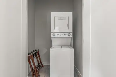 a microwave sitting on top of a washer and dryer at Basecamp Resorts Canmore in Canmore