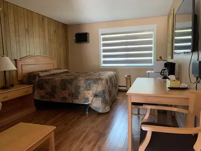 a hotel room with a bed and a desk at Green View Motel and RV Park in Greenwood