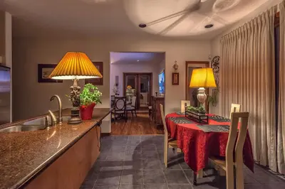 a kitchen and living room with a table with a red table cloth at Whytecliff Park place near ocean in West Vancouver