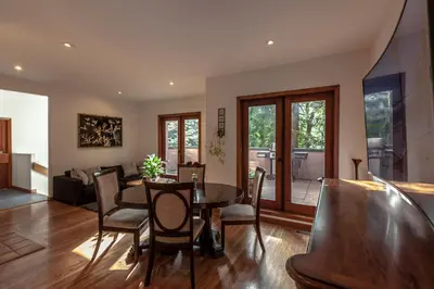 a dining room and living room with a table and chairs at Whytecliff Park place near ocean in West Vancouver