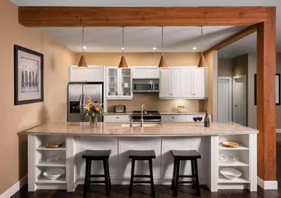 a kitchen with a large island with bar stools at Outback Lakeside Vacation Homes in Vernon