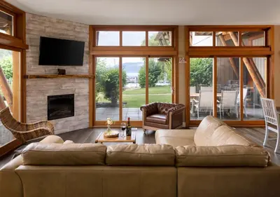 a living room with a couch and a fireplace at Outback Lakeside Vacation Homes in Vernon