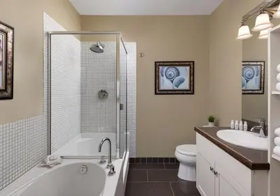 a bathroom with a tub and a toilet and a sink at Outback Lakeside Vacation Homes in Vernon