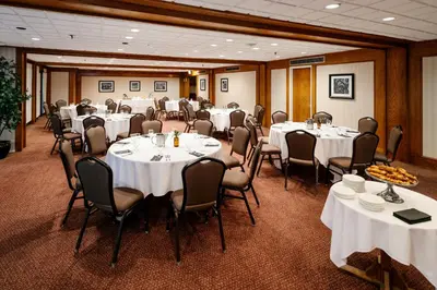 a conference room with white tables and chairs at Chateau Jasper in Jasper