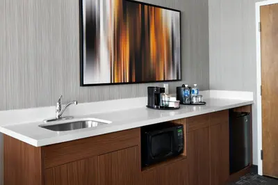 a bathroom counter with a sink and a microwave at Courtyard by Marriott Edmonton Downtown in Edmonton