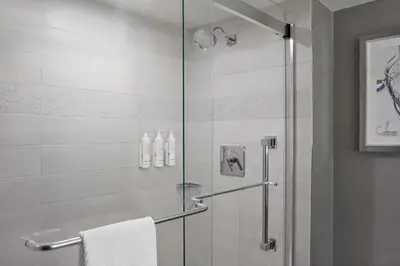 a bathroom with a shower with a glass door at Calgary Marriott Downtown Hotel in Calgary