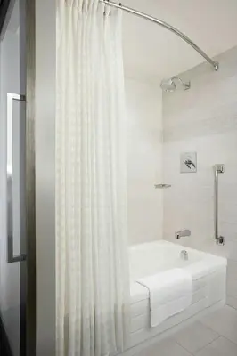 a white bathroom with a tub and a shower at Calgary Marriott Downtown Hotel in Calgary