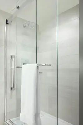 a glass shower door with a white towel at Calgary Marriott Downtown Hotel in Calgary