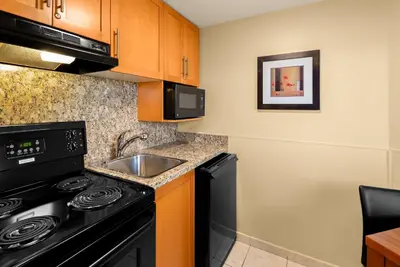 a kitchen with a stove and a sink at Best Western PLUS Inner Harbour Hotel in Victoria