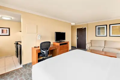 a hotel room with a bed and a desk with a television at Best Western PLUS Inner Harbour Hotel in Victoria