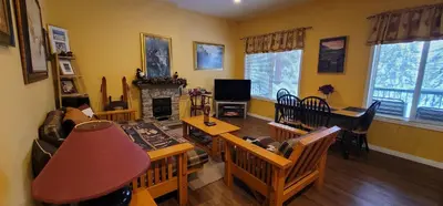 a living room with a couch and a table at Vacation Homes by The Bulldog- Berker's Suite A in Silver Star