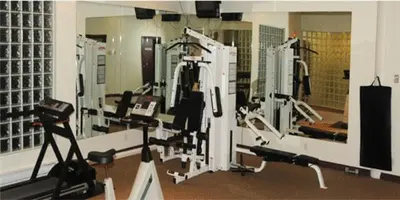 a gym with several treadying machines in a room at Sea to Sky Hotel and Conference Centre in Squamish