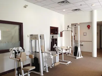 a gym with several treadmills and machines at Sea to Sky Hotel and Conference Centre in Squamish