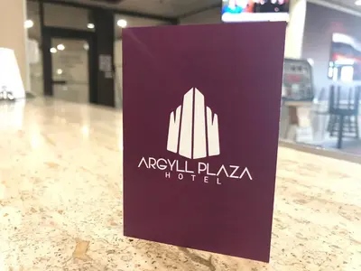 a purple sign on a counter in a store at Argyll Plaza Hotel in Edmonton