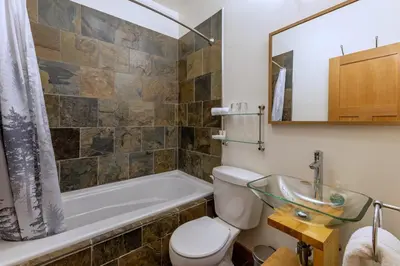 a bathroom with a toilet and a tub and a sink at Canyon Ridge Lodge in Golden