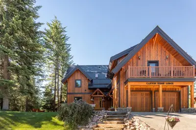 a large wooden house with a gambrel roof at Canyon Ridge Lodge in Golden