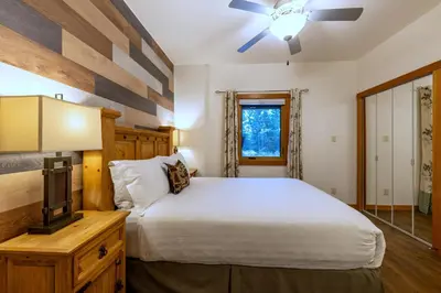 a bedroom with a bed and a tv on a dresser at Canyon Ridge Lodge in Golden
