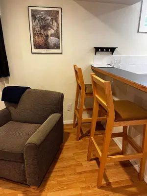a living room with a bar and a couch at Revelstoke Long Term in Revelstoke