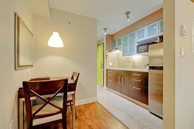 a kitchen with a wooden table and a dining room at Red Lion Inn and Suites Victoria in Victoria