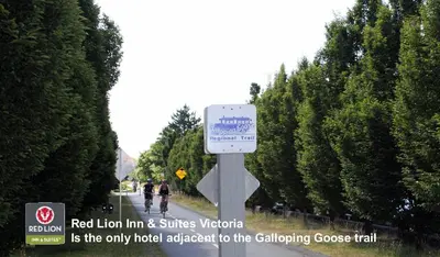 a sign on the side of a road with trees at Red Lion Inn and Suites Victoria in Victoria