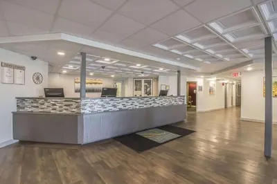 a lobby with a reception desk in a building at Quality Inn West Edmonton in Edmonton