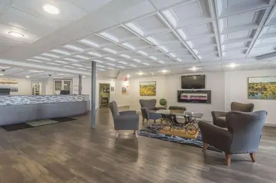a lobby with a waiting room with chairs and a table at Quality Inn West Edmonton in Edmonton