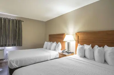 a hotel room with two beds and a window at Quality Inn West Edmonton in Edmonton
