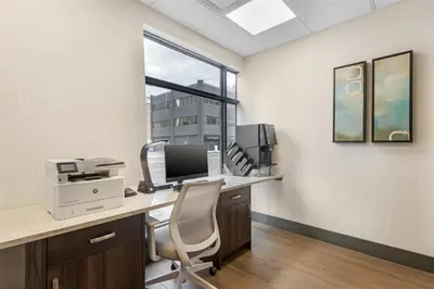 an office with a desk with a computer and a chair at Best Western Plus Suites Downtown Calgary in Calgary