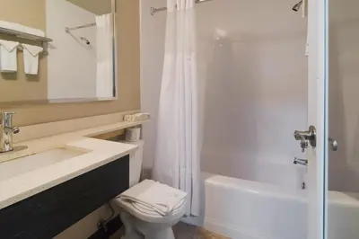 a bathroom with a toilet and a sink and a shower at Canadas Best Value Inn & Suites Kamloops in Kamloops