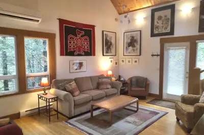 a living room with a couch and a table at The Cabin at Moon Dance in Garden Bay