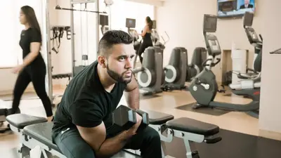 a man sitting on a bench in a gym at River Cree Resort & Casino in Edmonton